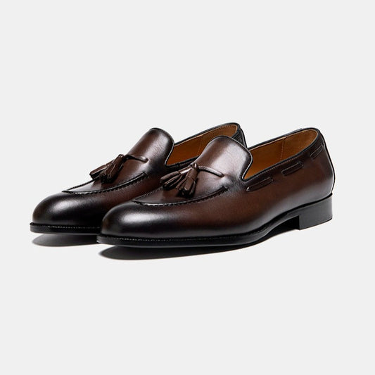 Lunepebbla black leather tassel loafers side profile showing tassels and Blake-stitched sole