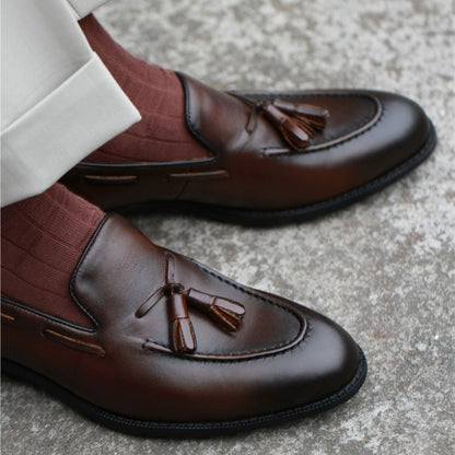 Lunepebbla close-up of twin leather tassels and apron stitching on full-grain leather vamp