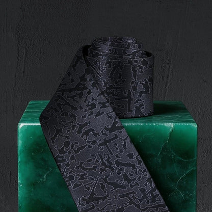 Lunepebbla abstract textured silk necktie rolled showing fabric weight and silk quality