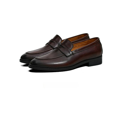 Lunepebbla brown waxed calfskin penny loafers worn with denim showing burnished finish on foot