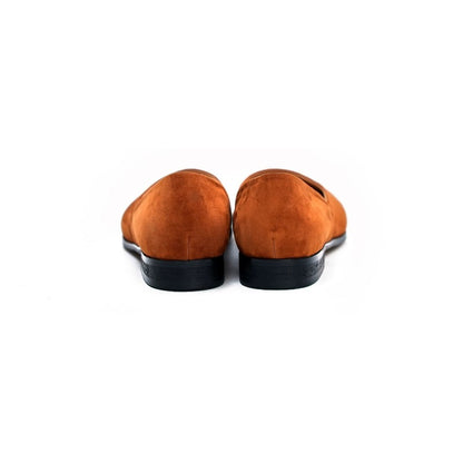 Lunepebbla black leather pointed-toe loafers worn with tailored trousers on foot