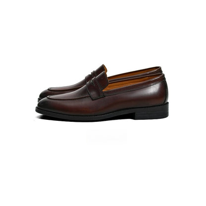 Lunepebbla black waxed calfskin penny loafers worn with blue denim showing polished finish