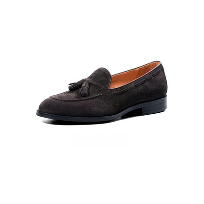 Lunepebbla tobacco suede tassel loafers worn with light trousers showing relaxed silhouette