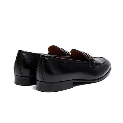 Lunepebbla black leather horsebit loafers worn with dark trousers showing polished leather
