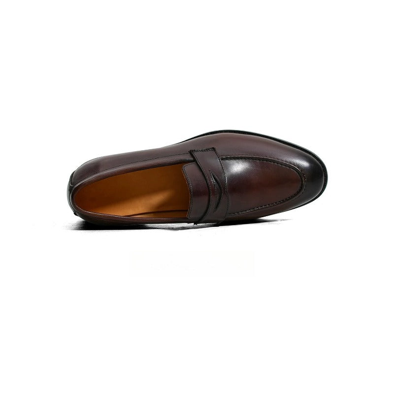 Lunepebbla waxed calfskin penny loafers worn with tailored trousers showing penny strap detail